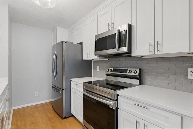 16109 Rambling Vine Dr E, Tampa, FL 33624 - kitchen with stainless steel appliances, backsplash, light countertops, and white cabinetry