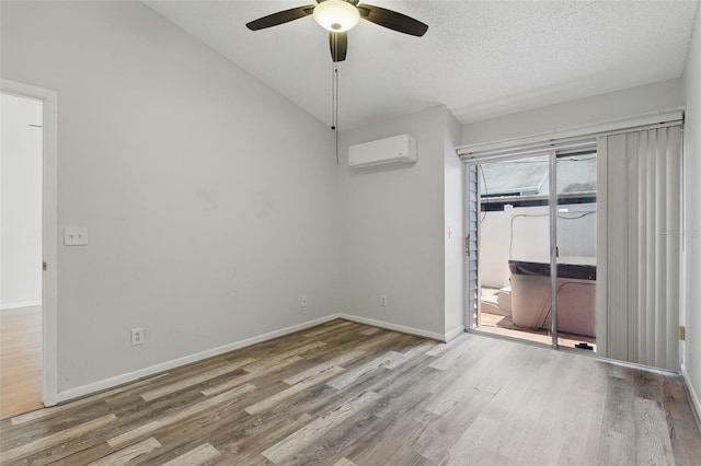 16109 Rambling Vine Dr E, Tampa, FL 33624 - empty room featuring a wall mounted AC, wood finished floors, a ceiling fan, baseboards, and a textured ceiling