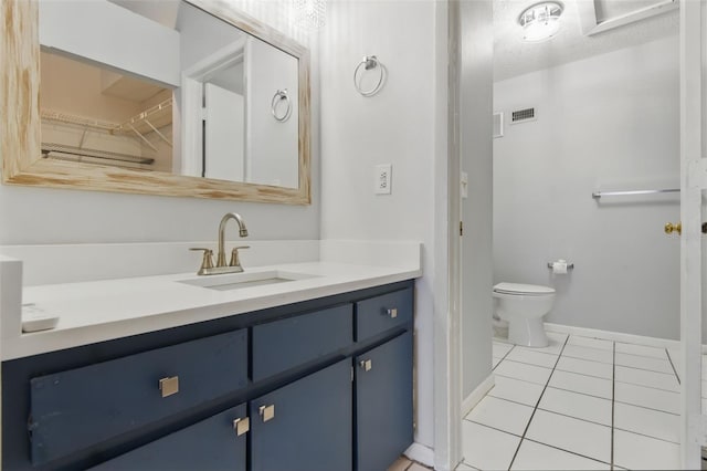 16109 Rambling Vine Dr E, Tampa, FL 33624 - bathroom with tile patterned flooring, vanity, baseboards, and toilet