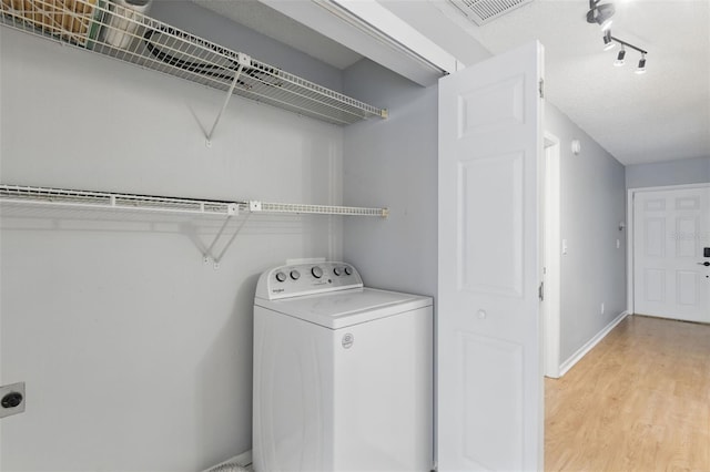 16109 Rambling Vine Dr E, Tampa, FL 33624 - laundry area with washer / clothes dryer, light wood-style flooring, and rail lighting