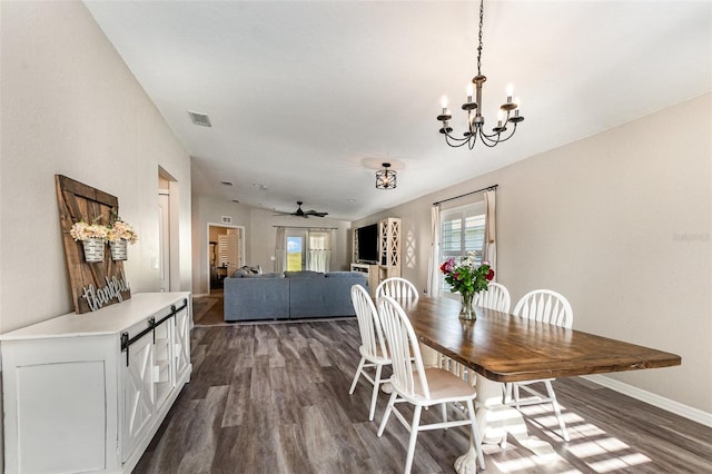6050 Eagle Pointe Dr, Lakeland, FL 33812 - dining area featuring dark wood-style flooring, a chandelier, baseboards, and ceiling fan