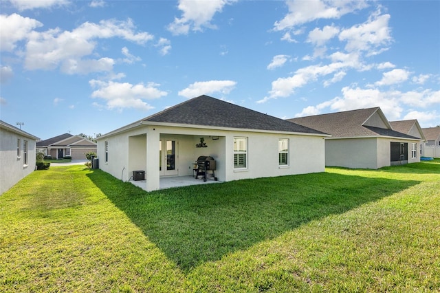 6050 Eagle Pointe Dr, Lakeland, FL 33812 - rear view of house with stucco siding, a patio, a yard, and roof with shingles