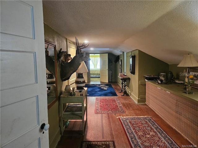 754 NE 2nd Ave, Crystal River, FL 34428 - hall with a textured ceiling, wood finished floors, lofted ceiling, and baseboards