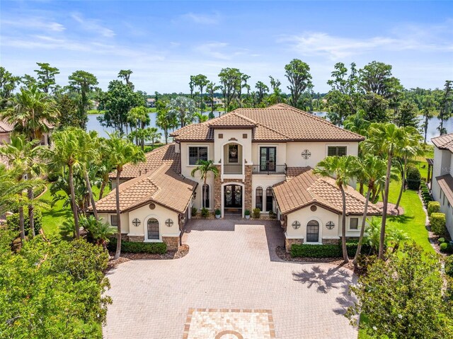 17301 Ladera Estates Blvd, Lutz, FL 33548 - mediterranean / spanish-style house featuring french doors, stucco siding, decorative driveway, and stone siding