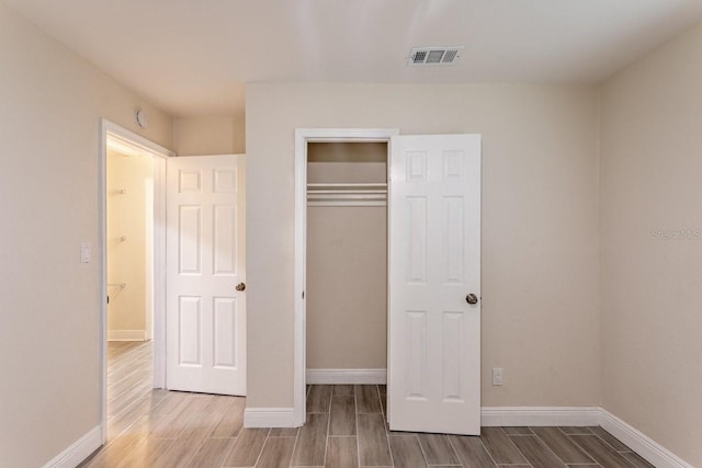 4611 17th Ave N, Saint Petersburg, FL 33713 - unfurnished bedroom featuring wood finish floors and a closet