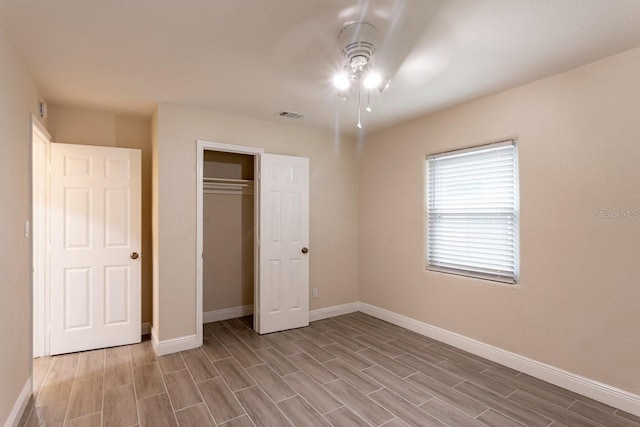 4611 17th Ave N, Saint Petersburg, FL 33713 - unfurnished bedroom with wood tiled floors, a closet, and a ceiling fan