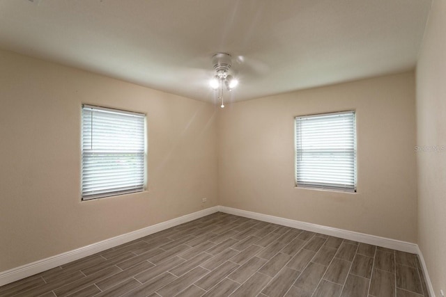 4611 17th Ave N, Saint Petersburg, FL 33713 - spare room featuring healthy amount of natural light, ceiling fan, and dark wood-style flooring