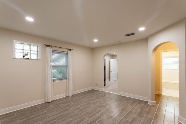 4611 17th Ave N, Saint Petersburg, FL 33713 - unfurnished room featuring arched walkways, recessed lighting, and wood finished floors