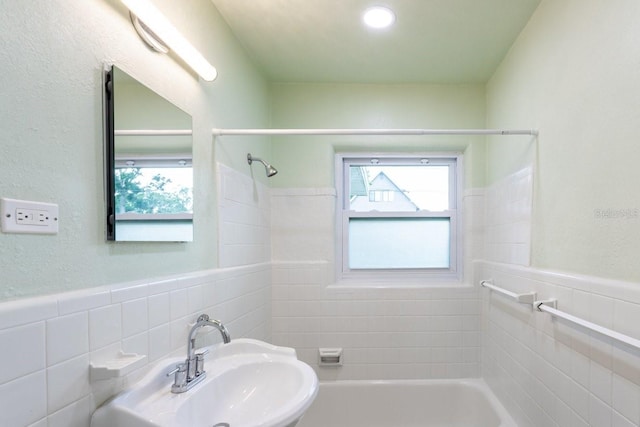 4611 17th Ave N, Saint Petersburg, FL 33713 - full bathroom featuring tile walls, plenty of natural light,  shower combination, and a wainscoted wall