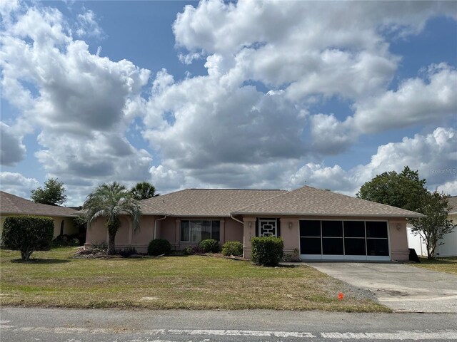 8130 Shalom Dr, Spring Hill, FL 34606 - ranch-style house featuring stucco siding, concrete driveway, a front yard, and an attached garage