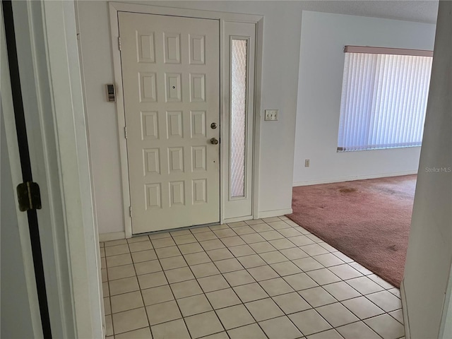 8130 Shalom Dr, Spring Hill, FL 34606 - foyer featuring light carpet, baseboards, and light tile patterned floors