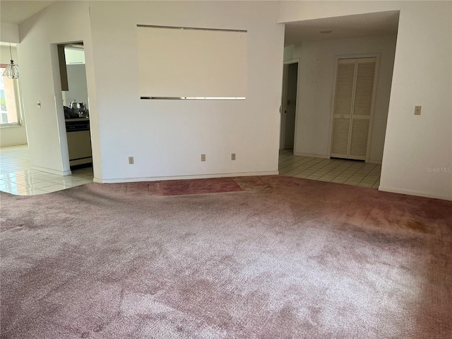 8130 Shalom Dr, Spring Hill, FL 34606 - empty room featuring carpet flooring, tile patterned floors, and baseboards
