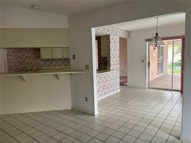 8130 Shalom Dr, Spring Hill, FL 34606 - unfurnished dining area featuring light tile patterned floors, baseboards, a textured ceiling, and a chandelier