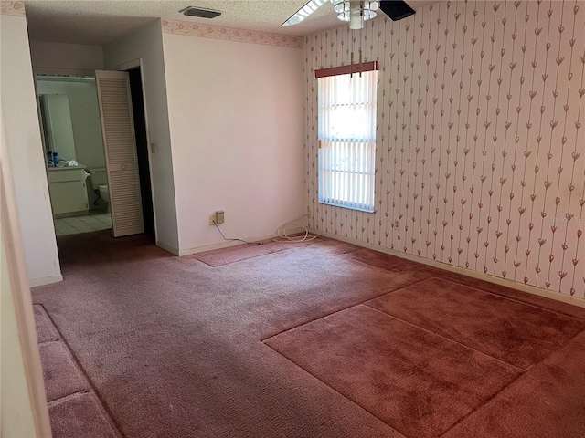 8130 Shalom Dr, Spring Hill, FL 34606 - carpeted empty room featuring a ceiling fan, wallpapered walls, and baseboards