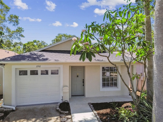 2742 Wilson Ct, Palm Harbor, FL 34684 - view of front of property with stucco siding, a shingled roof, a garage, and driveway