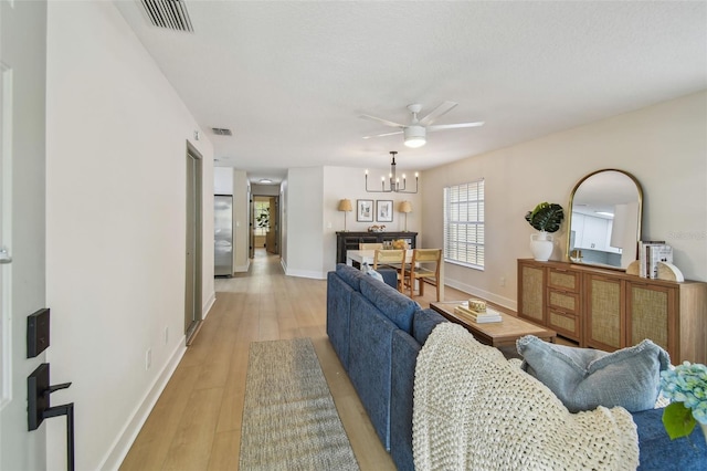 2742 Wilson Ct, Palm Harbor, FL 34684 - living room featuring light wood-type flooring, baseboards, a chandelier, and ceiling fan
