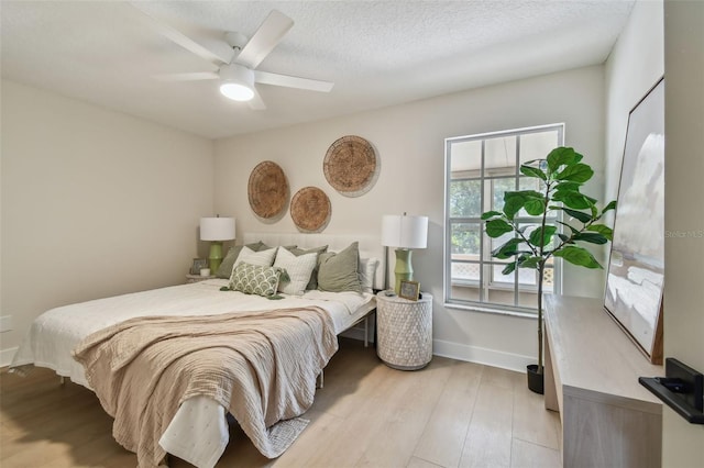 2742 Wilson Ct, Palm Harbor, FL 34684 - bedroom with light wood-style flooring, baseboards, and a ceiling fan