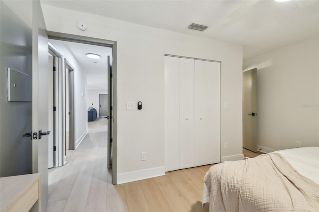 2742 Wilson Ct, Palm Harbor, FL 34684 - bedroom with light wood-style flooring, a closet, and baseboards