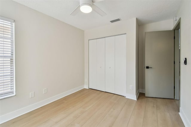 2742 Wilson Ct, Palm Harbor, FL 34684 - unfurnished bedroom featuring light wood-style flooring, a closet, and baseboards