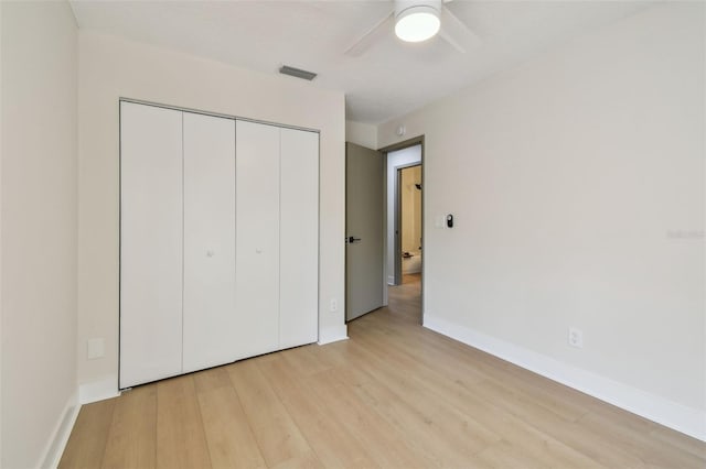 2742 Wilson Ct, Palm Harbor, FL 34684 - unfurnished bedroom featuring light wood-type flooring, a closet, baseboards, and a ceiling fan