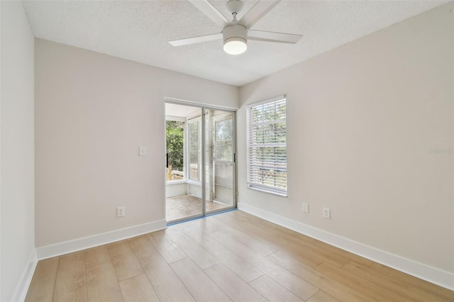 2742 Wilson Ct, Palm Harbor, FL 34684 - spare room with ceiling fan, light wood finished floors, baseboards, and a textured ceiling