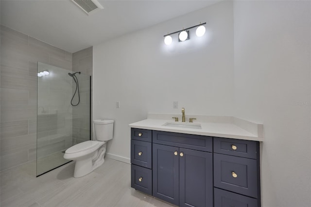 1801 N Morgan St Unit 5, Tampa, FL 33602 - bathroom with a tile shower, toilet, vanity, and baseboards