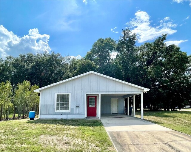 1310 Payne St, Auburndale, FL 33823 - view of front of house featuring concrete driveway, a front lawn, and an attached carport