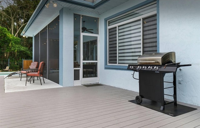 8701 Lake Calm Ln, Odessa, FL 33556 - wooden deck with a sunroom, grilling area, an outdoor pool, and a ceiling fan