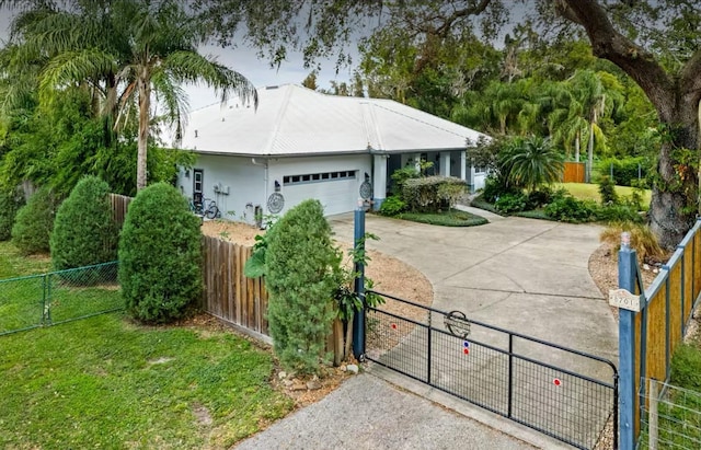 8701 Lake Calm Ln, Odessa, FL 33556 - ranch-style house featuring concrete driveway, stucco siding, a fenced front yard, a garage, and a gate