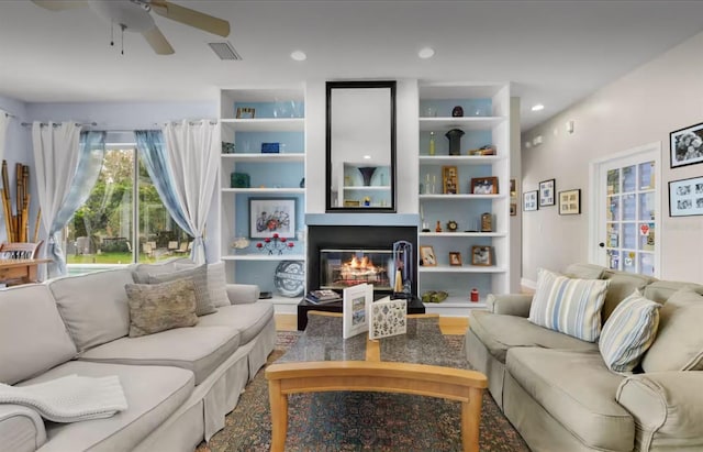 8701 Lake Calm Ln, Odessa, FL 33556 - living area with a glass covered fireplace, a ceiling fan, and recessed lighting