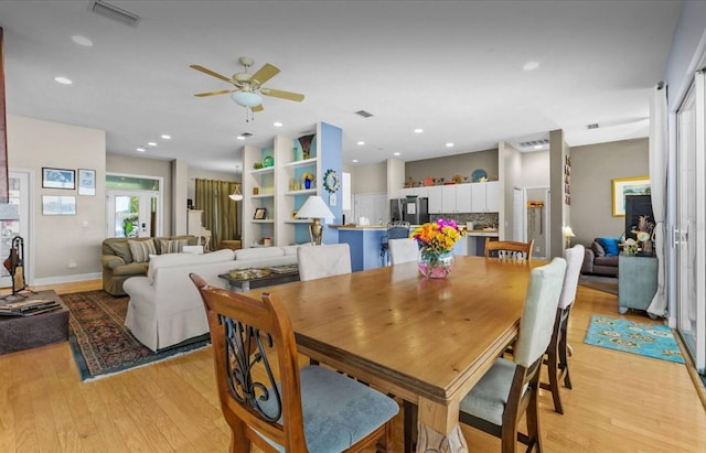 8701 Lake Calm Ln, Odessa, FL 33556 - dining space with light wood-style flooring, a ceiling fan, and recessed lighting