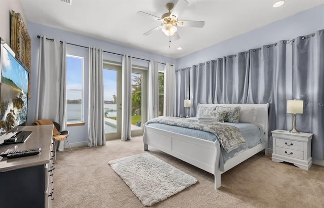 8701 Lake Calm Ln, Odessa, FL 33556 - bedroom with light carpet, baseboards, and a ceiling fan