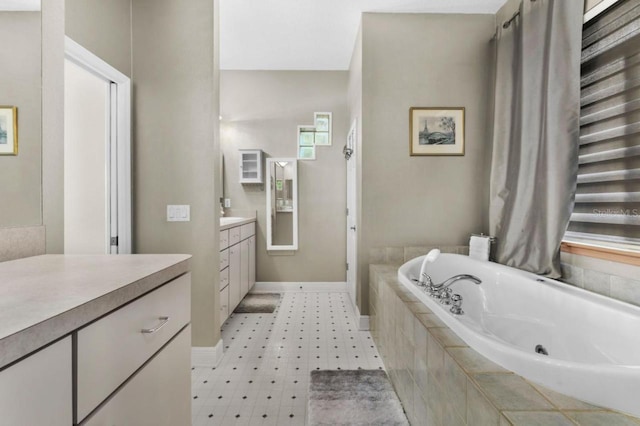 8701 Lake Calm Ln, Odessa, FL 33556 - full bathroom with vanity, a whirlpool tub, baseboards, and tile patterned floors