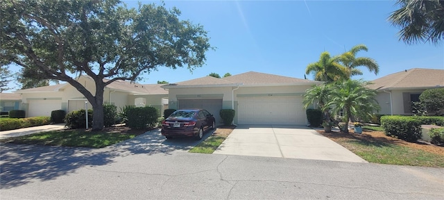 834 Tremont Greens Ln Unit 137, Sun City Center, FL 33573 - view of front of house featuring an attached garage, stucco siding, and concrete driveway