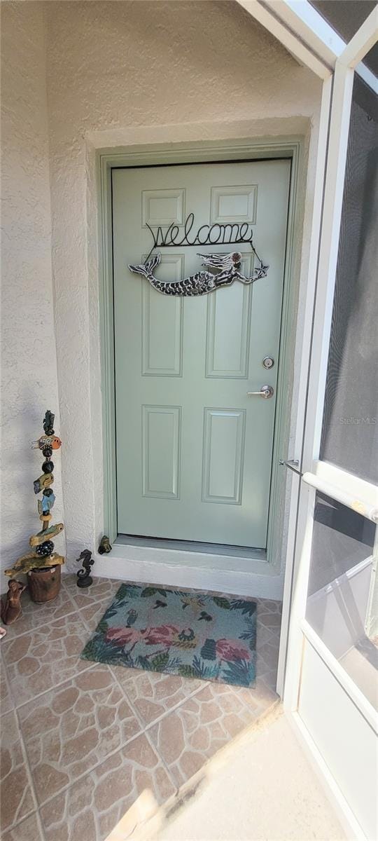 834 Tremont Greens Ln Unit 137, Sun City Center, FL 33573 - property entrance featuring stucco siding