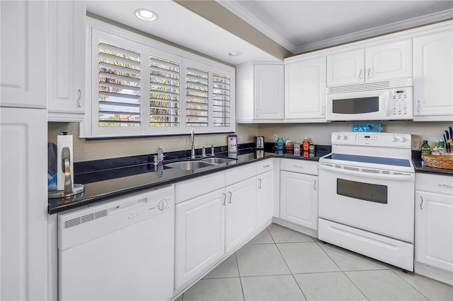 6309 Newtown Cir Unit 9B2, Tampa, FL 33615 - kitchen with white appliances, a sink, ornamental molding, dark countertops, and white cabinets