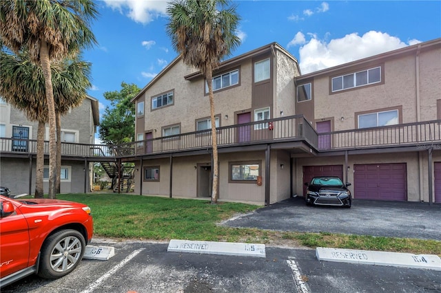 6309 Newtown Cir Unit 9B2, Tampa, FL 33615 - view of property with stairs and uncovered parking