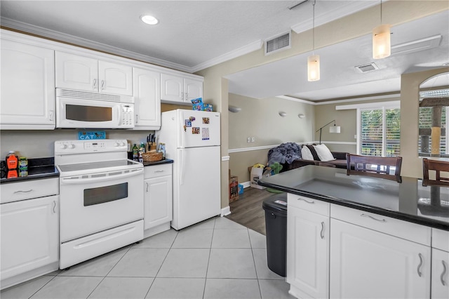 6309 Newtown Cir Unit 9B2, Tampa, FL 33615 - kitchen with white appliances, dark countertops, crown molding, light tile patterned floors, and hanging light fixtures