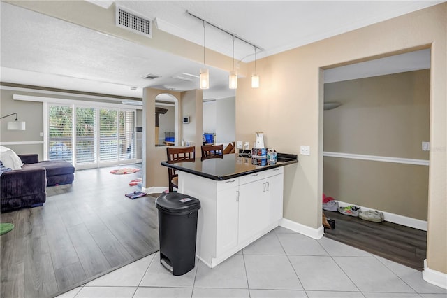 6309 Newtown Cir Unit 9B2, Tampa, FL 33615 - kitchen featuring a peninsula, dark countertops, open floor plan, and baseboards