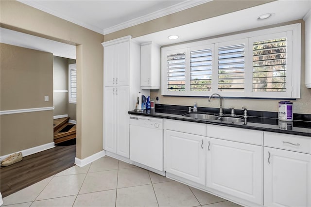 6309 Newtown Cir Unit 9B2, Tampa, FL 33615 - kitchen featuring dishwasher, a sink, crown molding, dark countertops, and baseboards