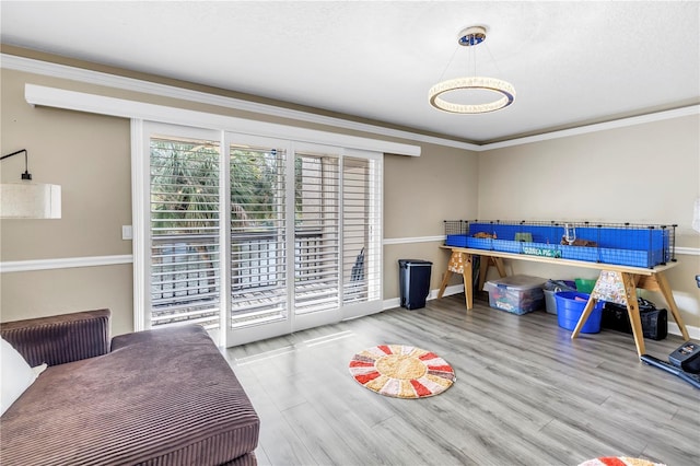 6309 Newtown Cir Unit 9B2, Tampa, FL 33615 - bedroom featuring wood finished floors, baseboards, crown molding, and access to exterior