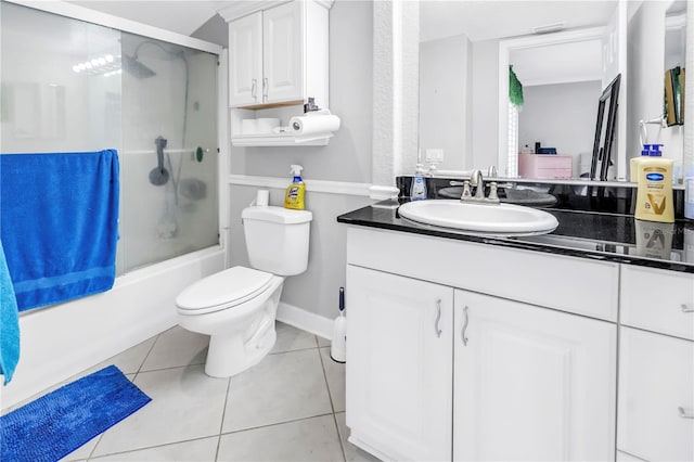 6309 Newtown Cir Unit 9B2, Tampa, FL 33615 - full bath featuring vanity, toilet, tile patterned floors, bath / shower combo with glass door, and baseboards