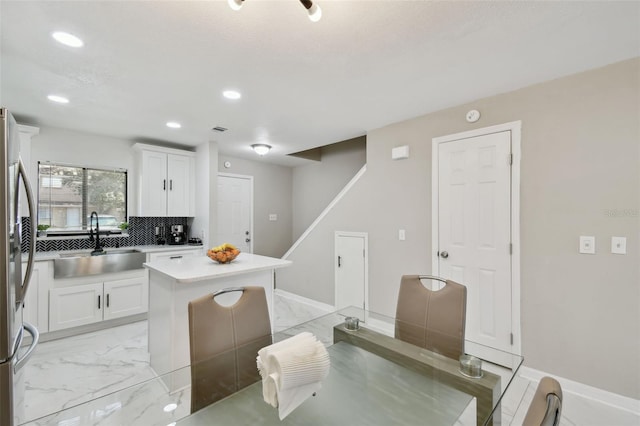 4017 Cedar Limb Ct, Tampa, FL 33614 - kitchen featuring a sink, a kitchen island, white cabinetry, freestanding refrigerator, and recessed lighting