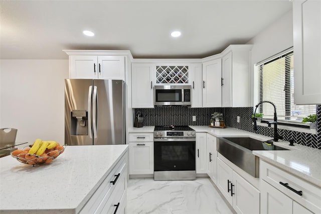 4017 Cedar Limb Ct, Tampa, FL 33614 - kitchen with stainless steel appliances, a sink, decorative backsplash, white cabinets, and recessed lighting