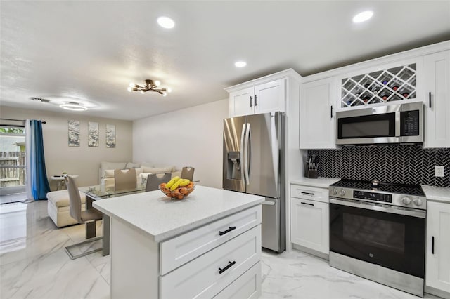 4017 Cedar Limb Ct, Tampa, FL 33614 - kitchen featuring stainless steel appliances, open floor plan, light marble finish floors, decorative backsplash, and a kitchen island