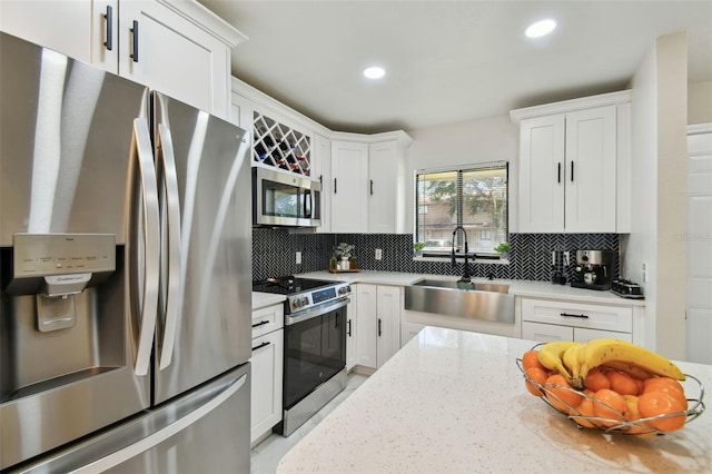 4017 Cedar Limb Ct, Tampa, FL 33614 - kitchen with stainless steel appliances, a sink, decorative backsplash, white cabinetry, and recessed lighting