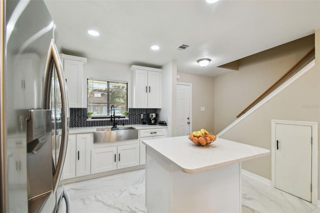 4017 Cedar Limb Ct, Tampa, FL 33614 - kitchen with stainless steel fridge, light marble finish floors, a sink, tasteful backsplash, and recessed lighting