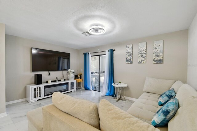 4017 Cedar Limb Ct, Tampa, FL 33614 - living area featuring baseboards and a textured ceiling