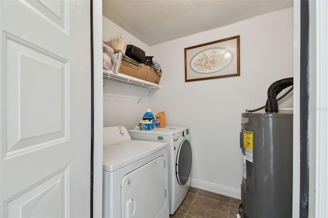 4017 Cedar Limb Ct, Tampa, FL 33614 - washroom with electric water heater, separate washer and dryer, dark tile patterned floors, and baseboards