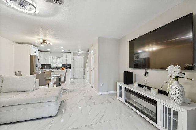 4017 Cedar Limb Ct, Tampa, FL 33614 - living room featuring baseboards, light marble finish flooring, and recessed lighting
